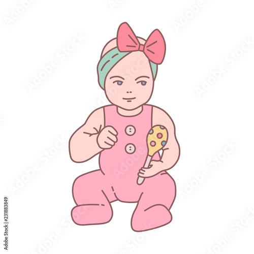 Pretty newborn baby girl dressed in romper suit sitting and holding rattle