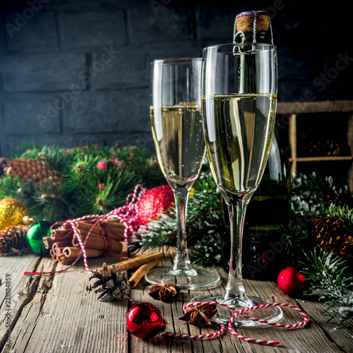 Two glasses of champagne with Christmas decoration on wooden background, Happy New Year and Xmas Celebration. Copy space