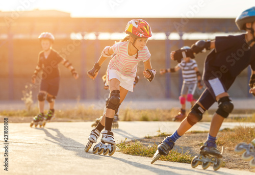 Canvas Print A girl training inline skating with other children