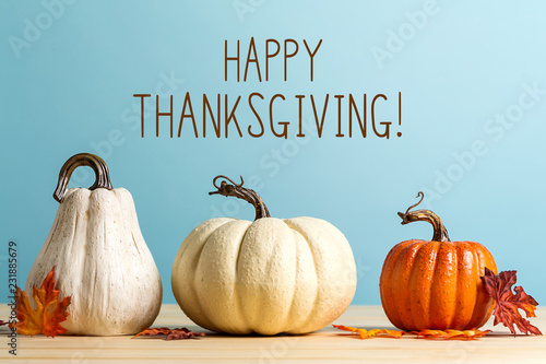 Thanksgiving message with pumpkins on a blue background