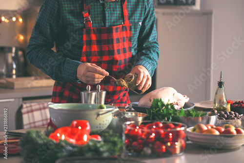 Man preparing delicious and healthy food in the home kitchen for christmas (Christmas Duck or Goose)