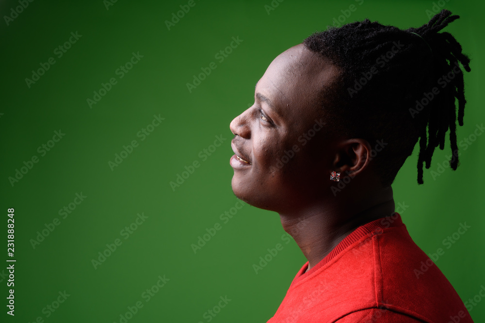 Young handsome African man from Kenya against green background Young handsome African man from Kenya against green background