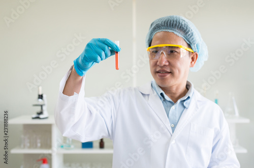 Scientist hands holding medical chemicals sample in test tube with blood sample