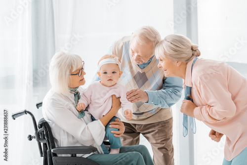 happy senior people playing with toddler in nursing home © LIGHTFIELD STUDIOS