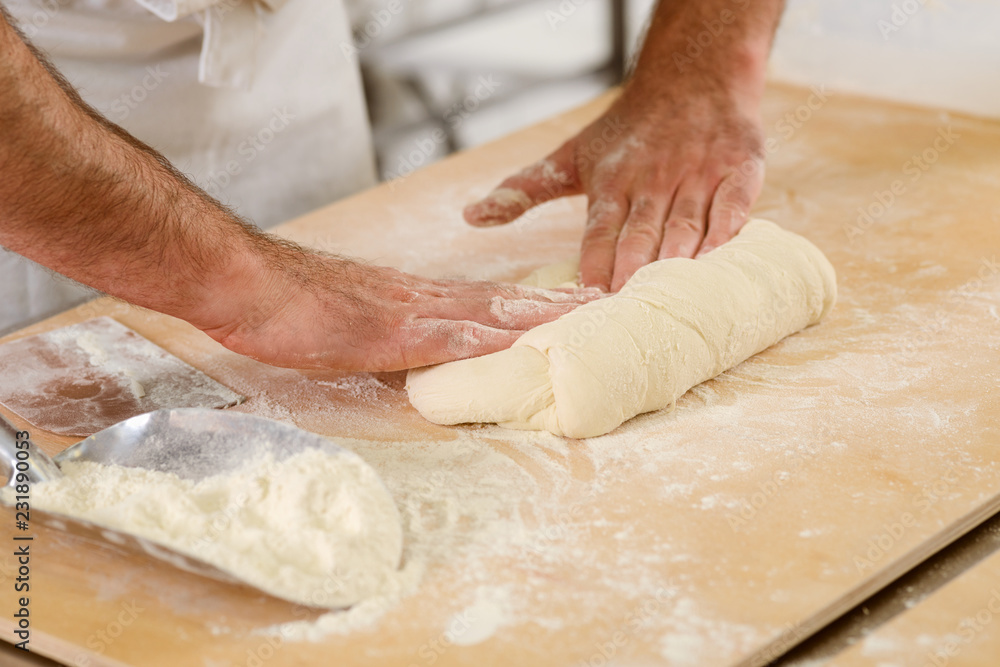 Man is kneading yeast dough
