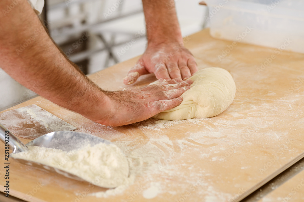 Male hands are kneading dough Male hands are kneading dough