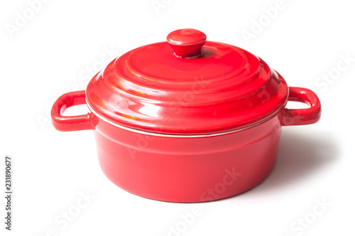 closeup of red ceramic saucepan on white background