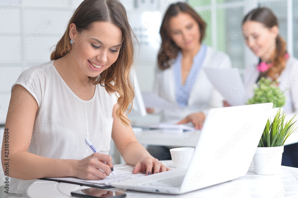 Portrait of young women working in modern office Portrait of young women working in modern office
