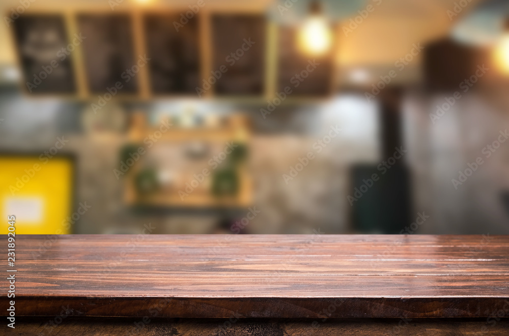 Selected focus empty brown wooden table and Coffee shop or restaurent blur background with bokeh image. for your photomontage or product display. Selected focus empty brown wooden table and Coffee shop or restaurent blur background with bokeh image. for your photomontage or product display.