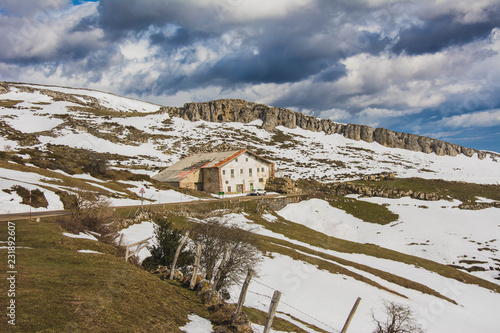 Beautiful remote house on slope of snowy mountains photo