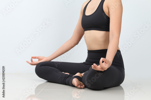 Close-up of of young woman meditating in pose of lotus,yoga poses