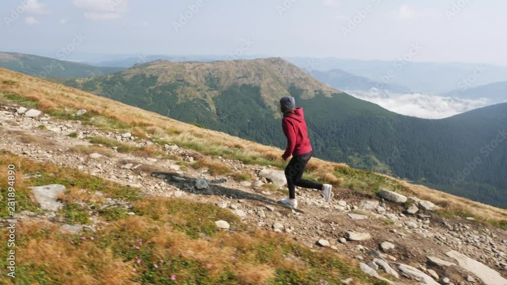 Woman is running climbing a mountain ridge. Woman is running climbing a mountain ridge.