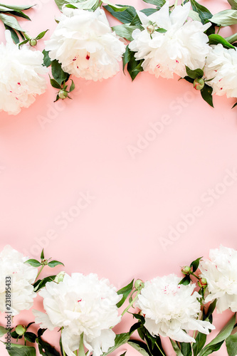 Frame of white peony flowers with space for text on pink background. Peony texture. Flat lay, top view. 
