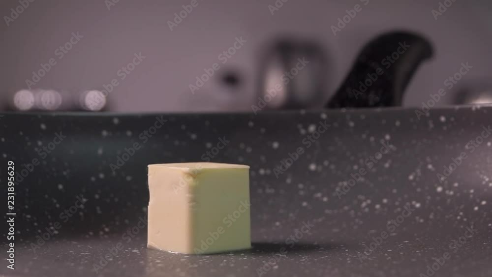 cube of butter fall on frying pan, slow motion, 240 fps cube of butter fall on frying pan, slow motion, 240 fps