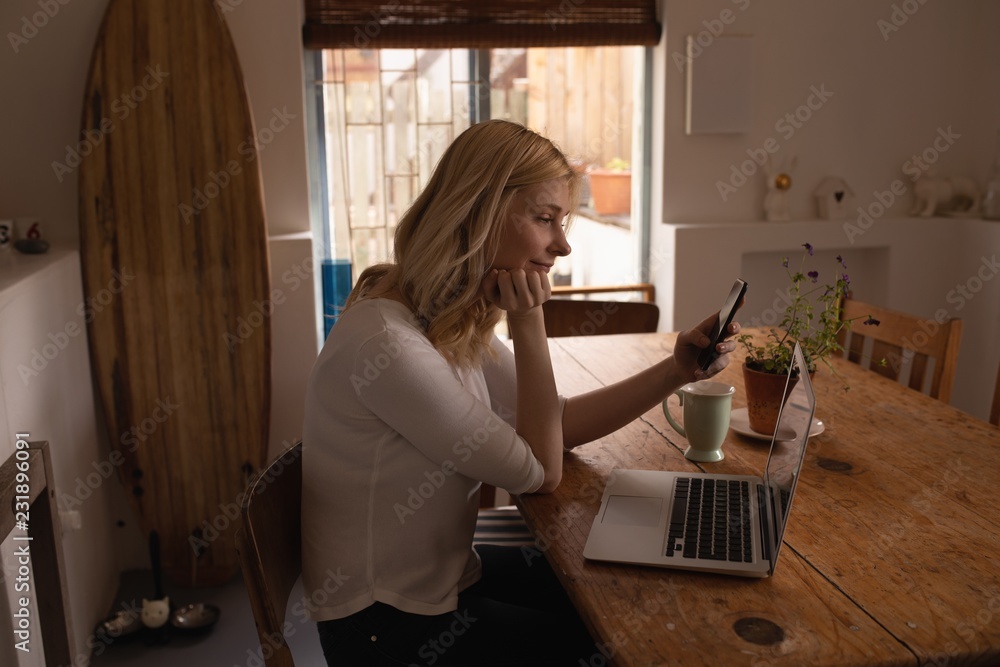 Side view of woman using smartphone at home Side view of woman using smartphone at home