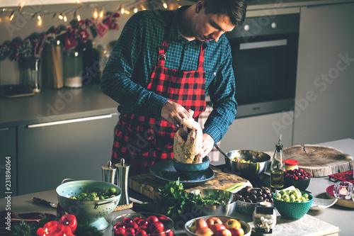 Man preparing delicious and healthy food in the home kitchen for christmas (Christmas Duck or Goose)