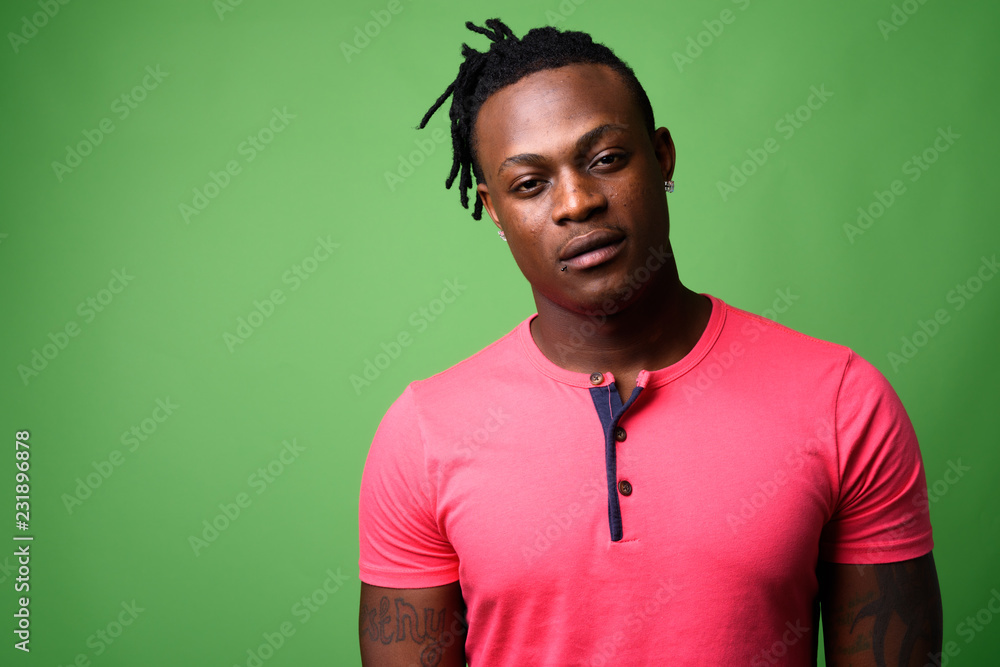 Young handsome African man from Kenya against green background Young handsome African man from Kenya against green background
