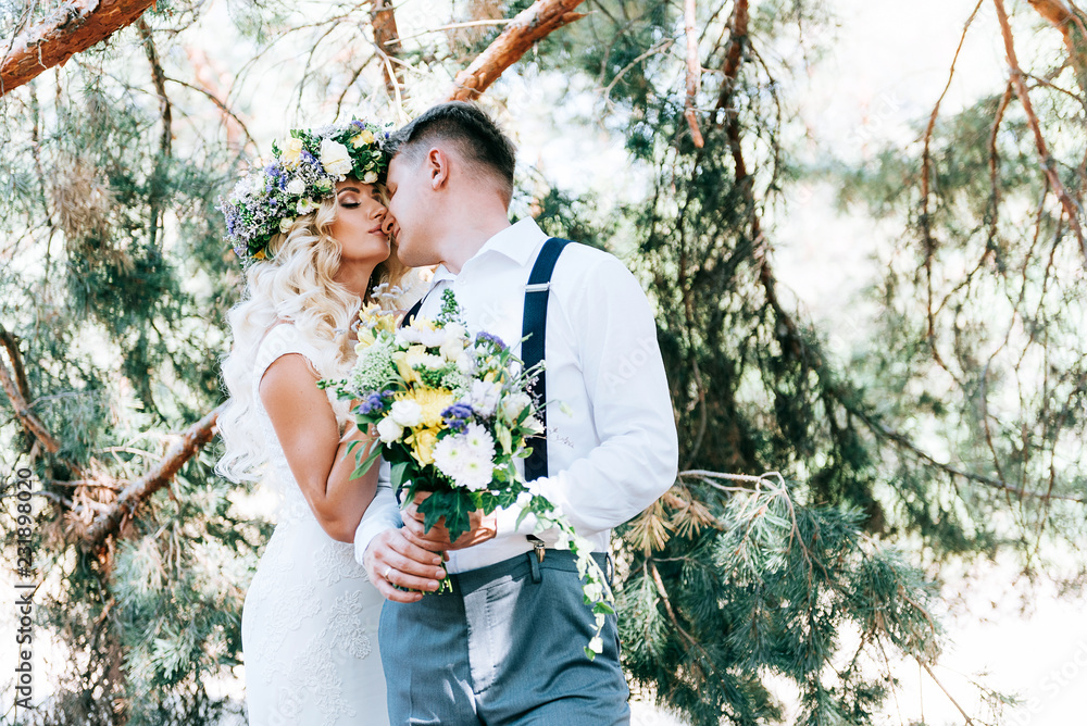 the bride and groom on a walk before the wedding banquet in the fairy forest near the castle. concept of love and creating a new family. the bride and groom on a walk before the wedding banquet in the fairy forest near the castle. concept of love and creating a new family.