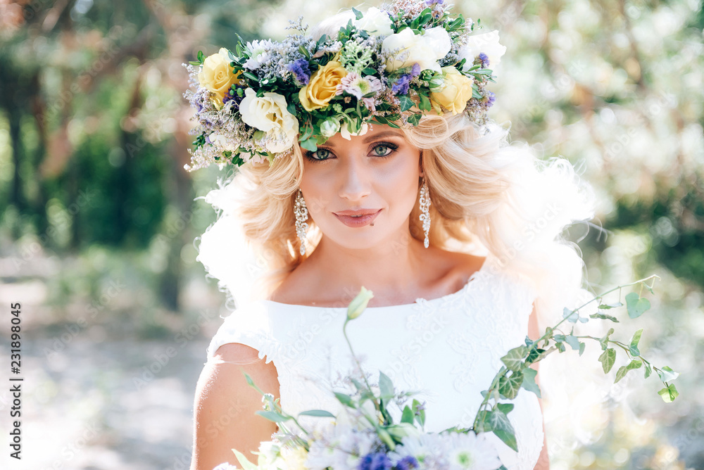 Beautiful bride in a luxurious dress with expensive makeup and hairstyle. with a fabulous bouquet in their hands and a wreath of flowers on their heads. preparing for a meeting with the groom. Beautiful bride in a luxurious dress with expensive makeup and hairstyle. with a fabulous bouquet in their hands and a wreath of flowers on their heads. preparing for a meeting with the groom.
