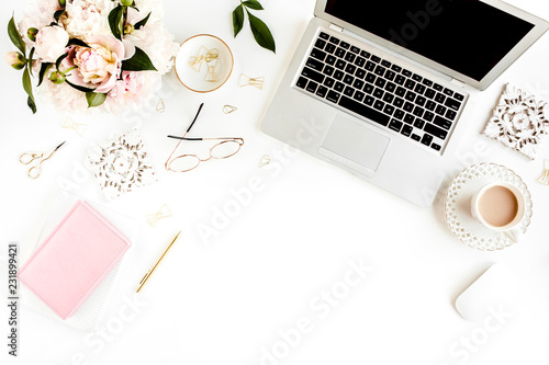 Fototapeta Naklejka Na Ścianę i Meble -  Flat lay women's office desk. Female workspace with laptop, pink peonies bouquet, accessories on white background. Top view feminine background.