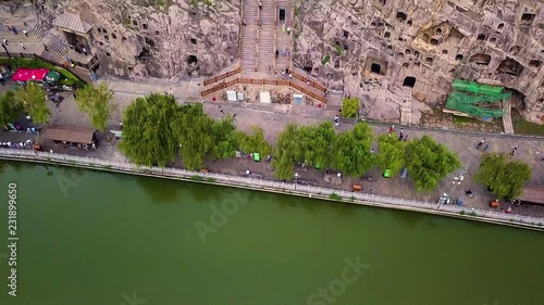 Zoom details over main statue of Fengxiangsi Cave at Longmen Grottes.  Henan, China photo