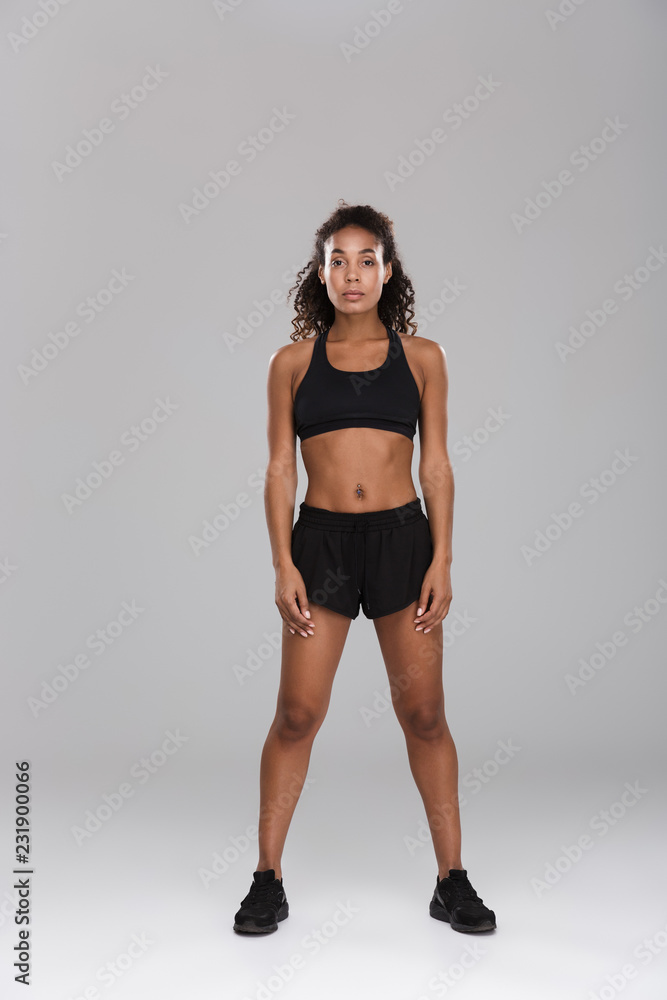 Full length portrait of an excited afro american sportswoman