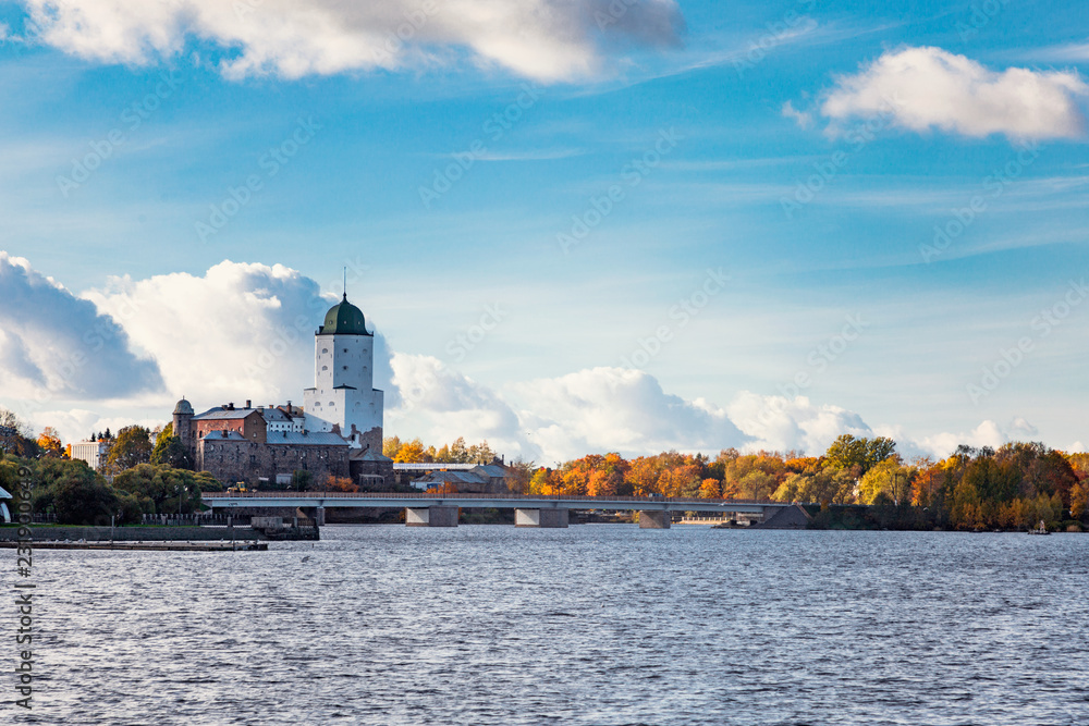 Landscape with water, bridge and St. Olaf's tower. Sunny autumn day in Vyborg