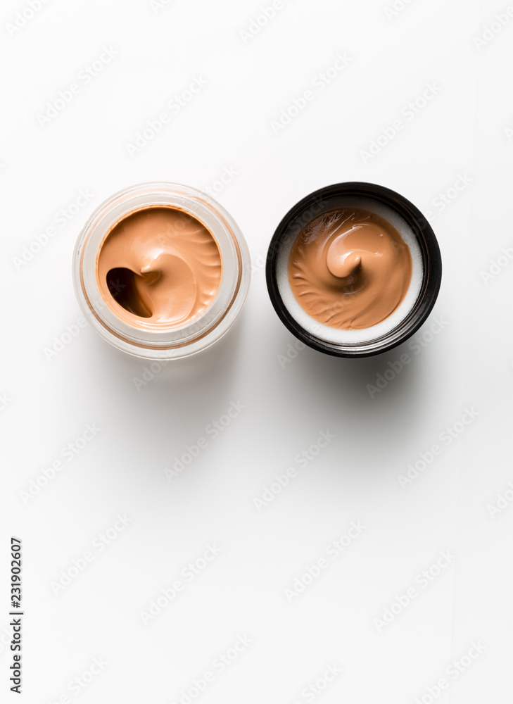 Jar and cap with tonal means for the face on a white background. View from above. Jar and cap with tonal means for the face on a white background. View from above.