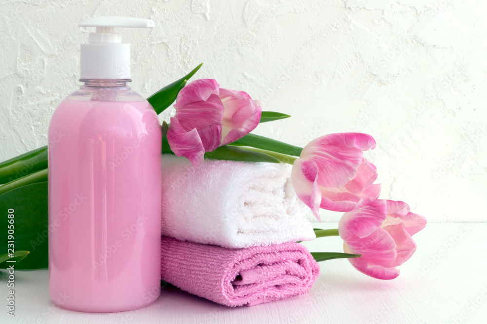 Liquid soap and two towels on a white background. Liquid soap and two towels on a white background.