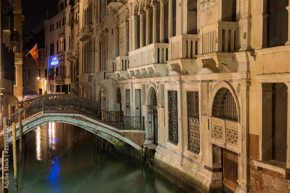 Houses along the canal and the bridge  in Venice in night