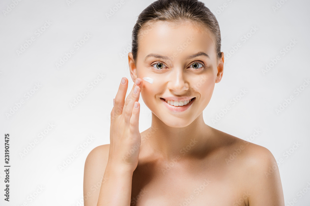 young beautiful woman applying white cream on face young beautiful woman applying white cream on face