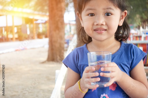 Portrait of asian kid drinking glass of water