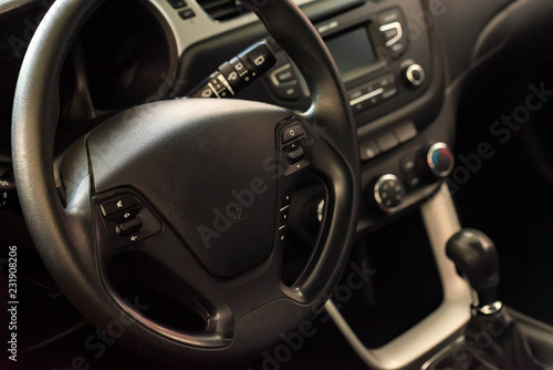 Steering wheel of modern car close up