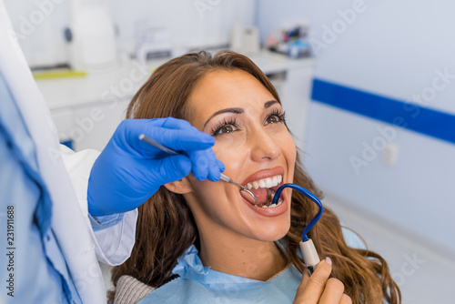 Professional handsome dentist examining teeth