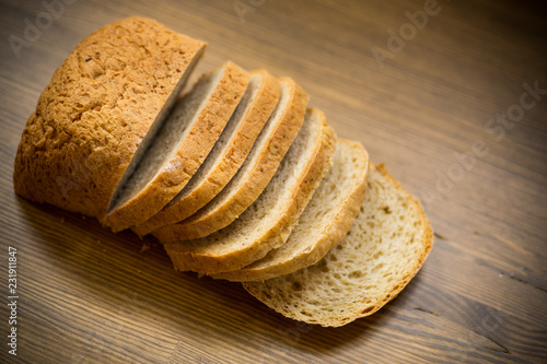 fresh homemade bread sliced on wooden background