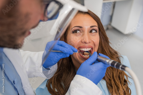 Dentist examining a patient s teeth in the dental office