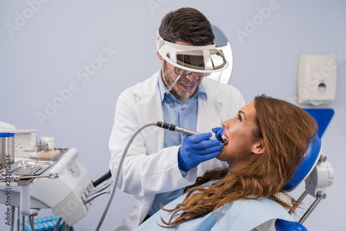 Dentist examining a patient s teeth in the dental office