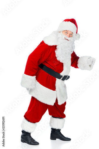 bearded santa claus walking in red costume isolated on white