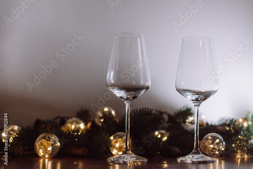 Christmas decoration with two glasses  and lights on a wooden background, Happy New Year. 