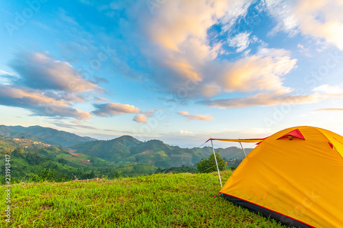 Camping orange tent on the mountain during sunrise in Chiang Rai  Thailand.