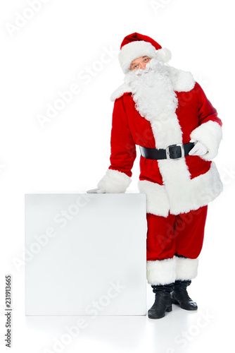 santa claus posing near white empty cube with copy space isolated on white