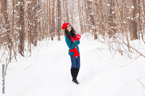 Beautiful young woman walking in the winter snowy nature © satura_