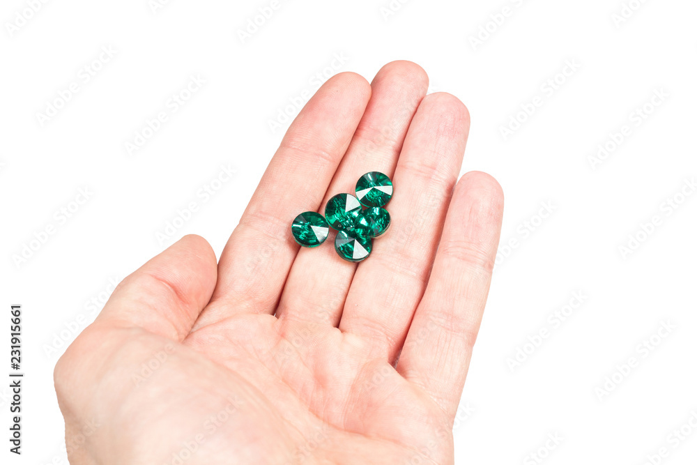 Gems emeralds in hand on white background Gems emeralds in hand on white background