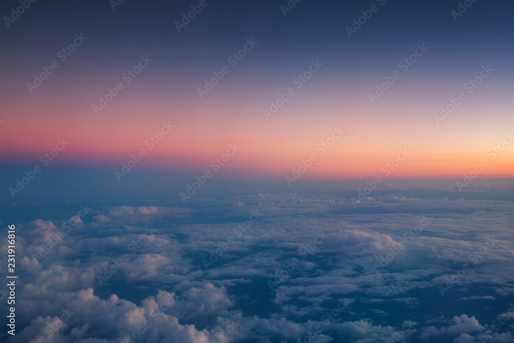 Flying above the clouds. Aerial view from the airplane window