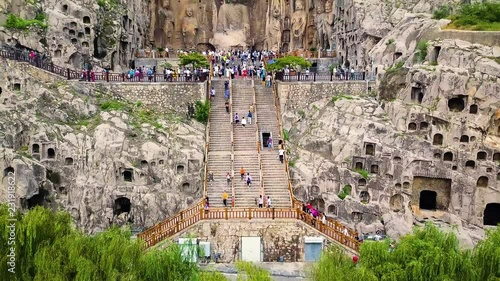 Visitors climbing upstairs to reach Fengxiangsi Cave. Finest buddhist art in Louyang, China photo