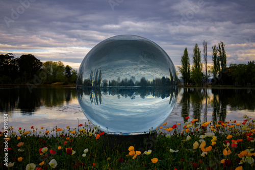 Lake reflections on a water filled glass ball