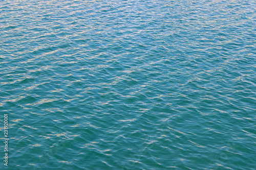 Blue green sea water surface texture summer abstract diagonal wallpaper background detail