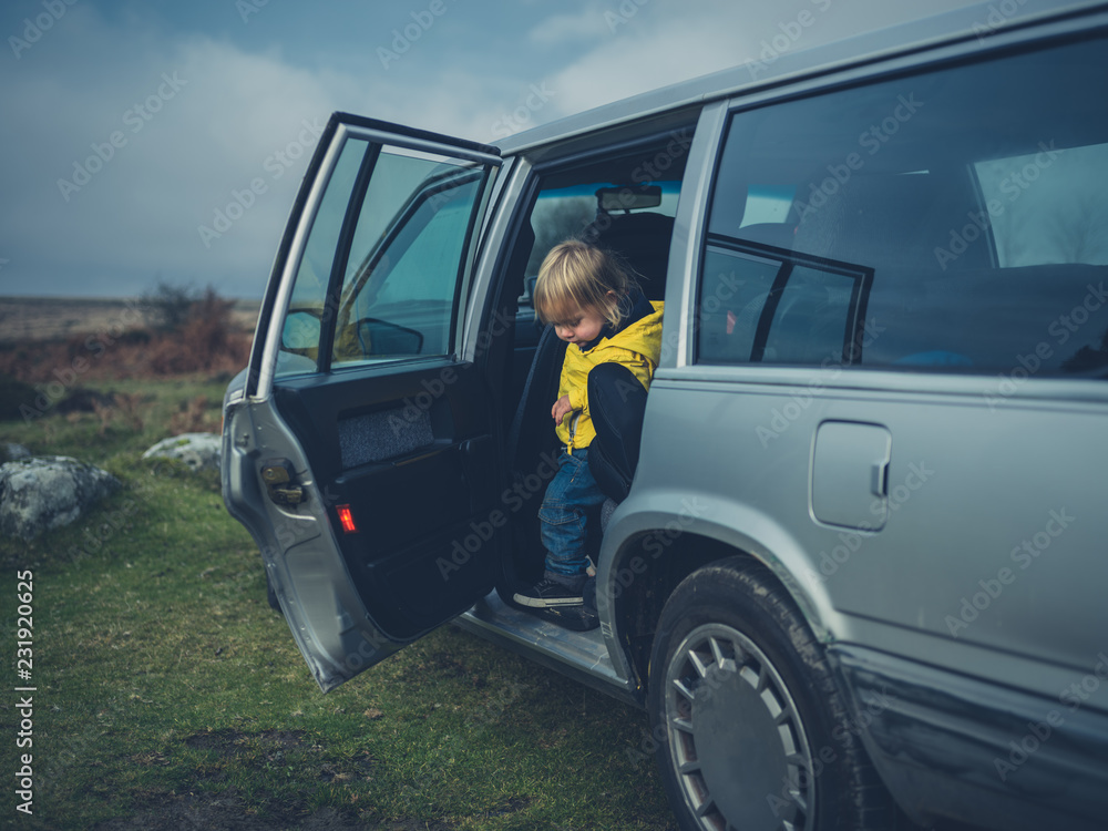 Toddler getting out of car on the moor Toddler getting out of car on the moor