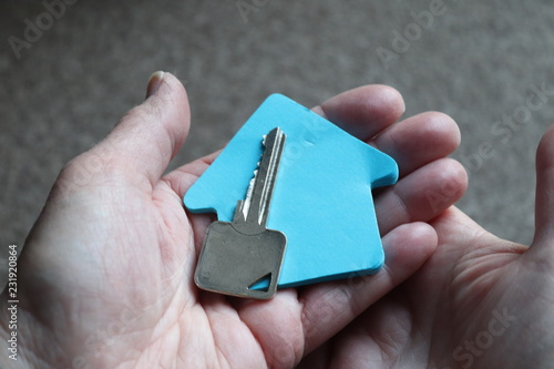 house key with house shape space. humn hand holding key photo