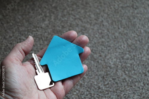 house key with house shape space. humn hand holding key photo